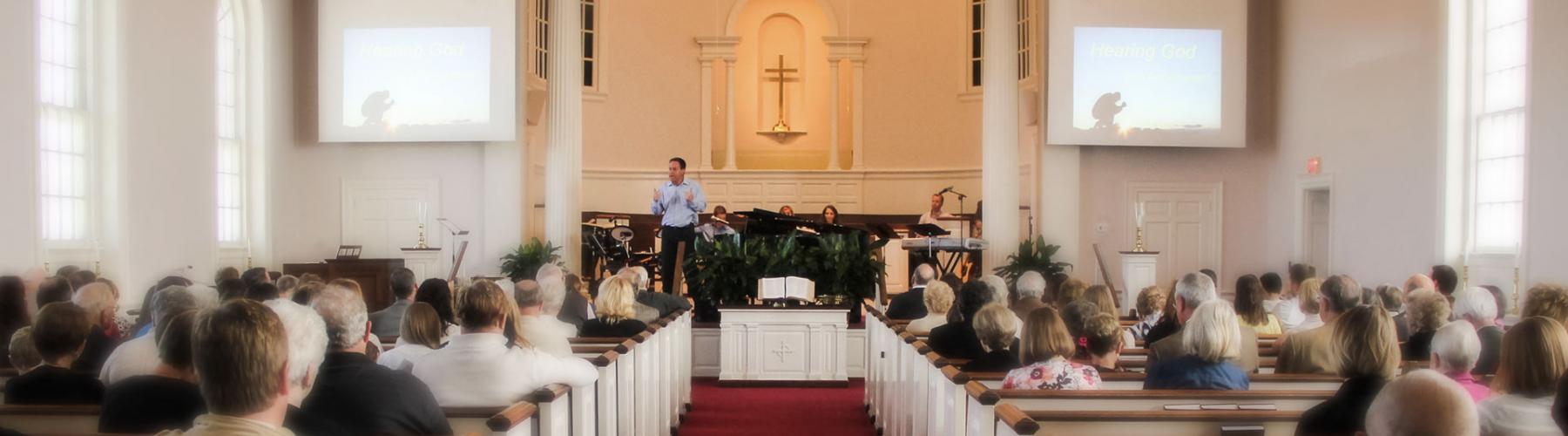 Congregation Listens to Pastor Deliver a Sermon